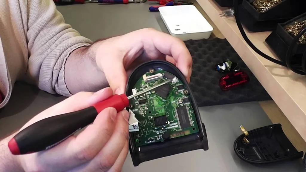 Handheld barcode scanner being repaired by FixVault technician