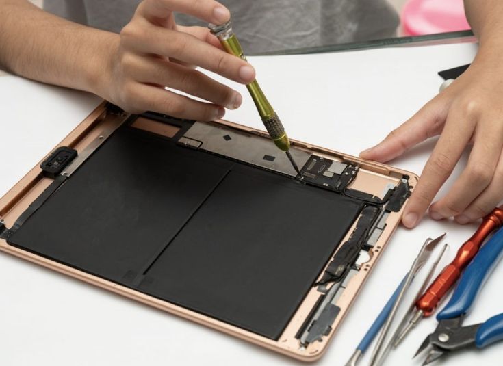 iPad tablet being repaired on professional workbench at FixVault Dubai